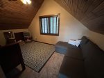 Loft sleeping area with full/twin bunk and sleeping couch